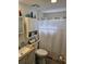 A bright bathroom with white fixtures, wood look floors, and ample storage space at 30 Riverview Dr, Fruitland Park, FL 34731