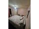 Bedroom showing a bed, dresser, closet with curtains and adjacent door at 30 Riverview Dr, Fruitland Park, FL 34731