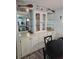 Dining room featuring a built-in china cabinet with glass shelving and nautical decor at 30 Riverview Dr, Fruitland Park, FL 34731