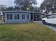 Charming home featuring a screened-in porch and well-manicured front yard with rock landscaping at 30 Riverview Dr, Fruitland Park, FL 34731