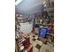Functional garage space features storage shelves, washer and dryer, and checkered flooring at 30 Riverview Dr, Fruitland Park, FL 34731