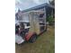 Red golf cart in good condition parked in the yard at 30 Riverview Dr, Fruitland Park, FL 34731