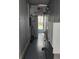 A clean hallway with white cabinets, speckled floors, an American flag and a blue door at 30 Riverview Dr, Fruitland Park, FL 34731