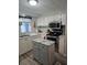 Well-equipped kitchen with stainless steel appliances, center island, and white cabinetry at 30 Riverview Dr, Fruitland Park, FL 34731