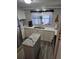Bright kitchen with a modern island, stainless steel appliances, and ample counter space at 30 Riverview Dr, Fruitland Park, FL 34731