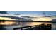 Scenic lake view featuring a wooden dock against the beautiful sunset at 30 Riverview Dr, Fruitland Park, FL 34731