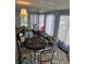 A sunroom featuring a table and chairs, rug, curtains, and many windows at 30 Riverview Dr, Fruitland Park, FL 34731