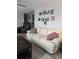 Comfortable living room with stylish decor, including a plush white sofa and modern wall art at 30 Riverview Dr, Fruitland Park, FL 34731