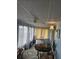 A living room featuring a table and chairs, rug, curtains, and many windows at 30 Riverview Dr, Fruitland Park, FL 34731