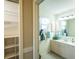 Bathroom featuring ample storage shelves, a window, vanity and a large mirror at 308 Santa Clara Cir, Lady Lake, FL 32159