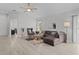 Bright and airy living room with hardwood floors and a comfy sectional at 3707 Gravel Ct, The Villages, FL 32163