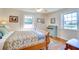 Sunlit bedroom featuring hardwood floors and two windows with backyard views at 422 W 11Th Ave, Mount Dora, FL 32757