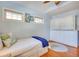 Bedroom with hardwood floors, light blue walls, and a built-in Murphy bed and dresser at 422 W 11Th Ave, Mount Dora, FL 32757