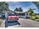 Ranch home with classic car in the driveway at 422 W 11Th Ave, Mount Dora, FL 32757