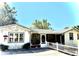 Charming cottage with mature trees, picket fence, bistro set, and decorative mural at 422 W 11Th Ave, Mount Dora, FL 32757