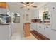 Quaint kitchen features white cabinetry, wooden countertops and center island, and stainless appliances at 422 W 11Th Ave, Mount Dora, FL 32757