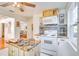 Open kitchen with an island, white appliances, and unique backsplash detail at 422 W 11Th Ave, Mount Dora, FL 32757