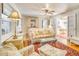 Bright living room featuring a comfy sofa and access to the dining area at 422 W 11Th Ave, Mount Dora, FL 32757