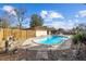 Backyard featuring an in-ground pool, privacy fence, and mature landscaping at 5640 Se 21St Ln, Ocala, FL 34480