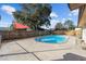 The backyard showcases an inviting private pool with a concrete deck, surrounded by a wooden fence at 5640 Se 21St Ln, Ocala, FL 34480
