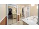Bathroom view featuring double vanity, tile flooring, and mirrored closet doors at 5640 Se 21St Ln, Ocala, FL 34480