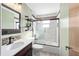Updated bathroom features a modern vanity, a glass-enclosed tub-shower, and stylish fixtures at 5640 Se 21St Ln, Ocala, FL 34480