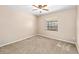 Cozy bedroom featuring neutral carpet, ceiling fan, and a window at 5640 Se 21St Ln, Ocala, FL 34480
