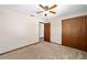 Bedroom view featuring neutral carpet, ceiling fan, and closet at 5640 Se 21St Ln, Ocala, FL 34480
