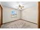 Bedroom view featuring neutral carpet, ceiling fan, and large window at 5640 Se 21St Ln, Ocala, FL 34480
