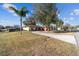Spacious front yard with long driveway leading to attached garage at 5640 Se 21St Ln, Ocala, FL 34480