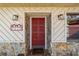 This front door is accented with stone and decorative wall lighting at 5640 Se 21St Ln, Ocala, FL 34480