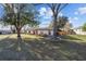 A well-maintained front yard showing a single-story house with stone accents and mature landscaping at 5640 Se 21St Ln, Ocala, FL 34480