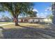 Well-maintained one-story home with stone accents, manicured landscaping, and an American flag at 5640 Se 21St Ln, Ocala, FL 34480