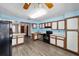 Bright kitchen features stainless steel appliances, modern backsplash, light cabinets, and durable laminate flooring at 5640 Se 21St Ln, Ocala, FL 34480