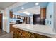 Charming kitchen with blue walls, wooden cabinets, and a stone-accent breakfast bar at 5640 Se 21St Ln, Ocala, FL 34480