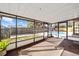 The enclosed lanai offers a view of the pool area and fenced backyard at 5640 Se 21St Ln, Ocala, FL 34480