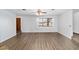 Living room with vinyl floors, a large window, and white walls at 5640 Se 21St Ln, Ocala, FL 34480