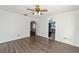 Open living room with vinyl floors and an archway leading to the kitchen at 5640 Se 21St Ln, Ocala, FL 34480