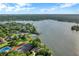Overhead shot of community amenities including tennis courts and pool with lake access, all surrounded by lush trees and landscaping at 624 Maple Oak Cir # 108, Altamonte Springs, FL 32701
