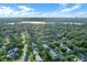 Scenic aerial view of the neighborhood showcasing lush greenery, well-maintained homes, and the tranquil lake in the distance at 624 Maple Oak Cir # 108, Altamonte Springs, FL 32701