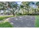Outdoor community basketball court surrounded by lush trees offers a space for recreation at 624 Maple Oak Cir # 108, Altamonte Springs, FL 32701