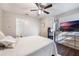 Comfortable bedroom with ceiling fan and large TV at 624 Maple Oak Cir # 108, Altamonte Springs, FL 32701