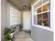 Front entry with white door and two potted plants at 624 Maple Oak Cir # 108, Altamonte Springs, FL 32701