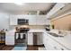 Updated kitchen featuring stainless steel appliances and white shaker cabinets at 624 Maple Oak Cir # 108, Altamonte Springs, FL 32701