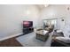 Living room with vaulted ceiling, hardwood floors, large TV, and comfy seating at 624 Maple Oak Cir # 108, Altamonte Springs, FL 32701