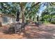 Outdoor patio area with brick pavers, seating, and large shade trees creating a relaxing and inviting space at 624 Maple Oak Cir # 108, Altamonte Springs, FL 32701