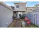 Small private patio with red metal table and chairs at 624 Maple Oak Cir # 108, Altamonte Springs, FL 32701
