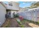 Private patio with red chairs and a small table at 624 Maple Oak Cir # 108, Altamonte Springs, FL 32701