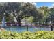 Community pool area enclosed by a fence, showcasing clear blue water and lounge chairs for relaxation by the poolside at 624 Maple Oak Cir # 108, Altamonte Springs, FL 32701
