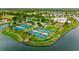 Aerial view of community with tennis and pickleball courts at 8592 Hempstead Way, Mount Dora, FL 32757